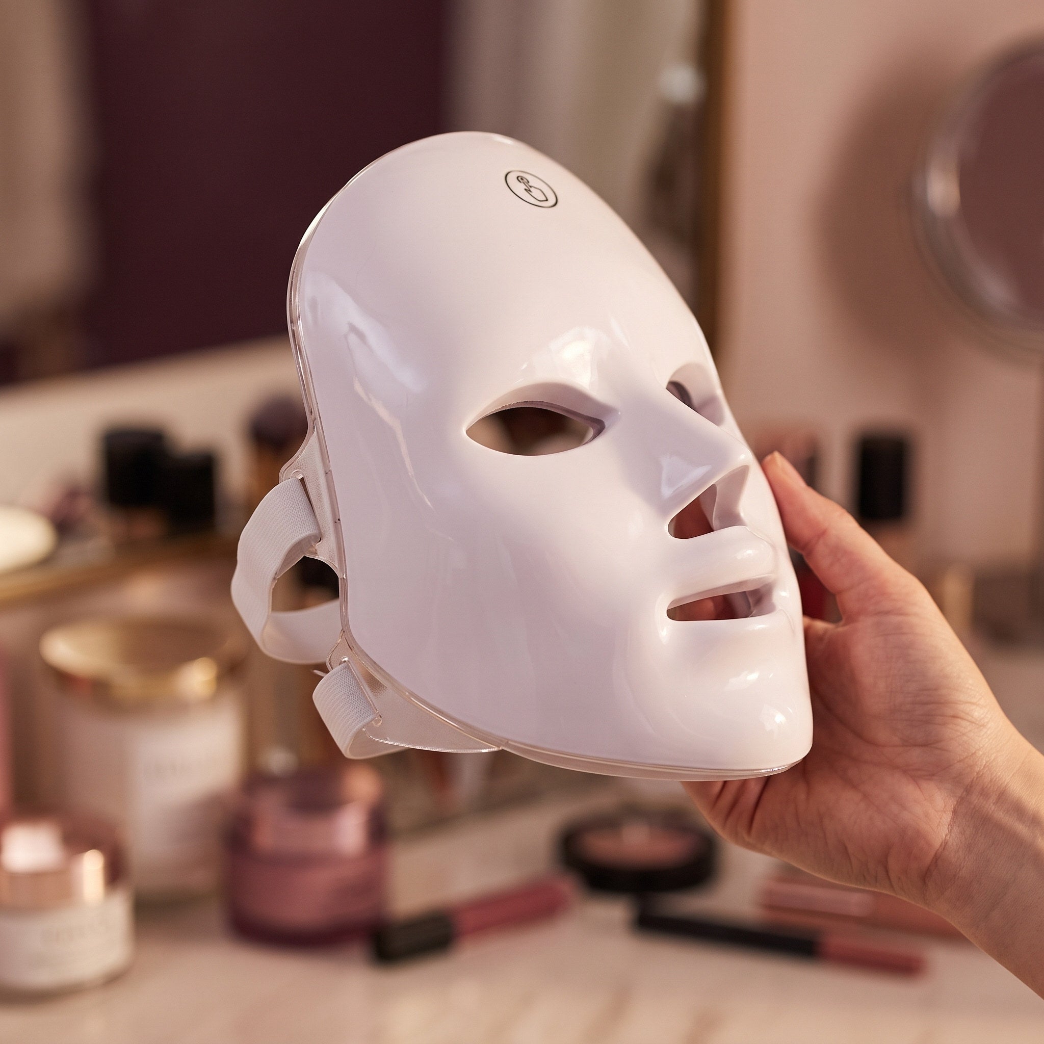 Glow Hour mask resting on a blush dressing table